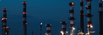 Refinery stacks at night